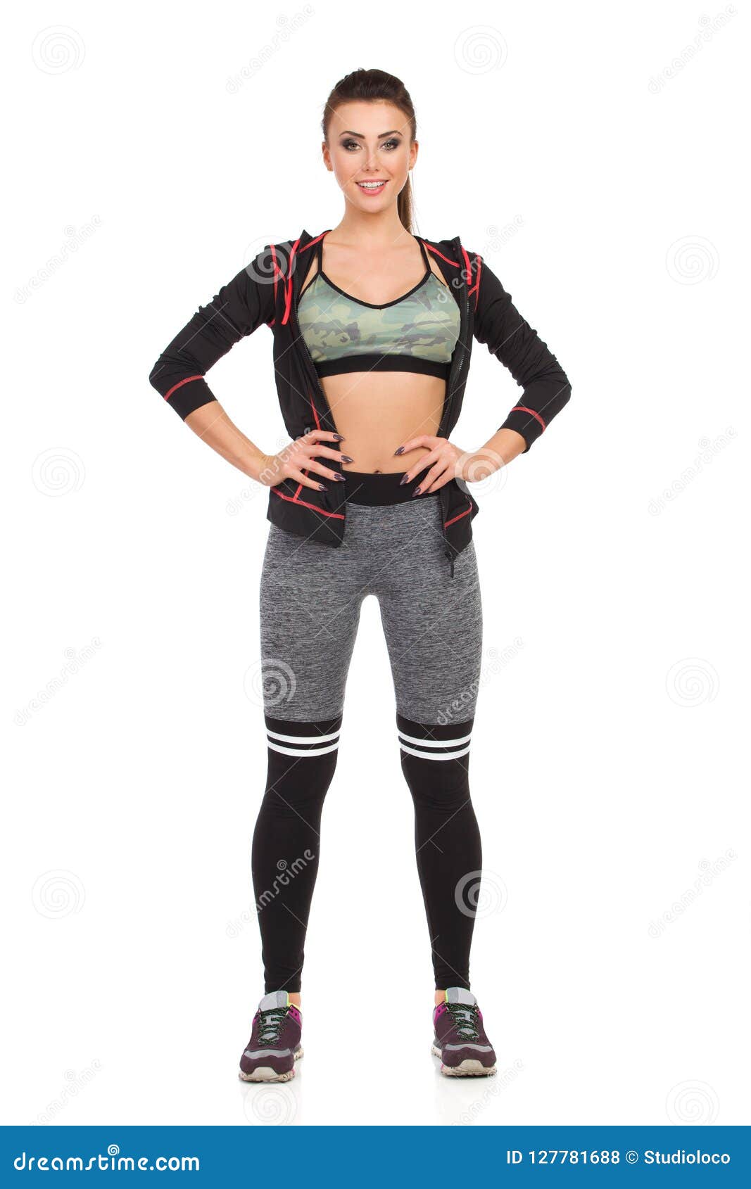 Beautiful Young Woman in Sports Clothes is Standing with Hand on Hip ...