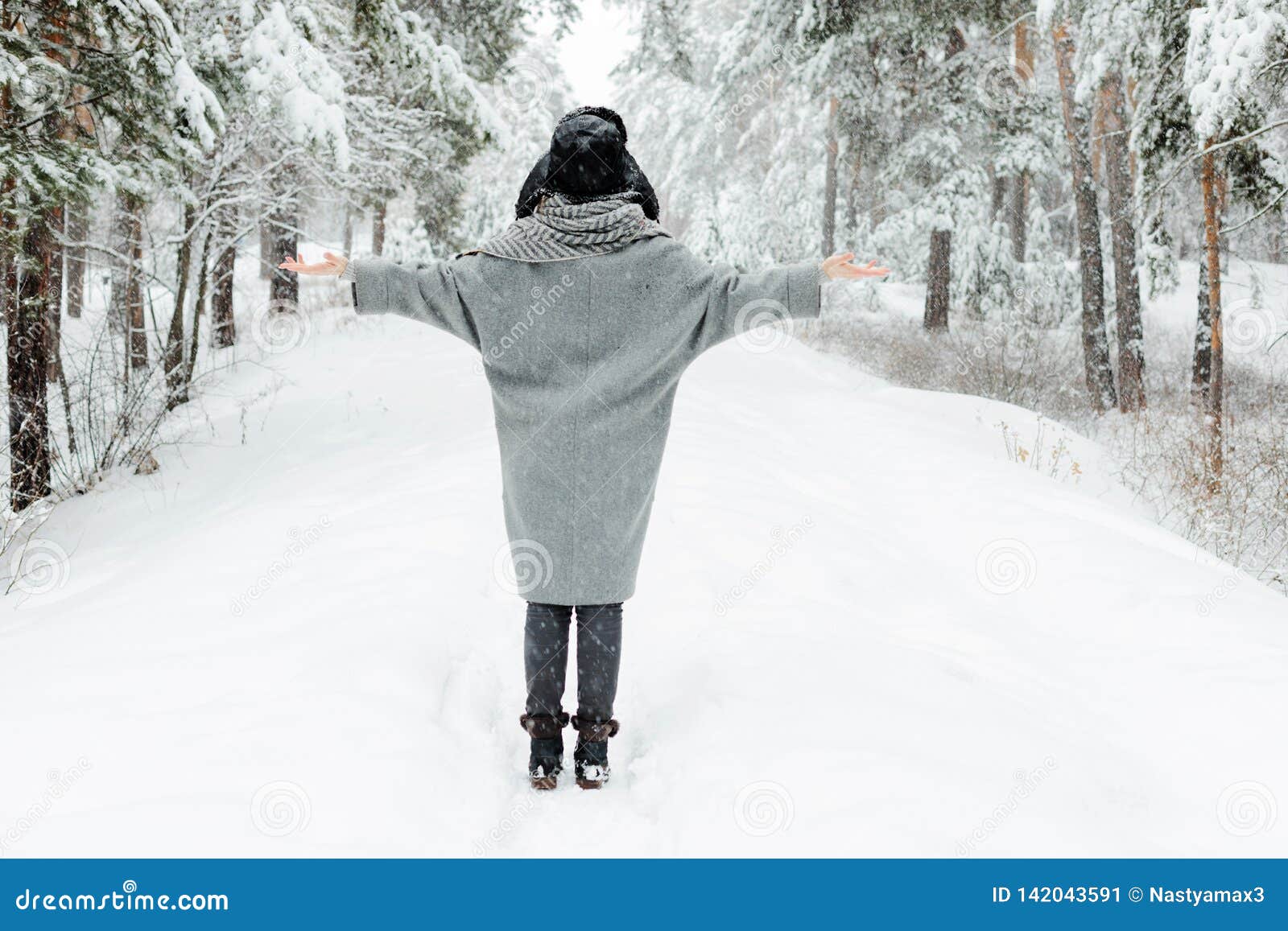 Beautiful Young Woman Standing Among Snowy Trees In Winter Forest And