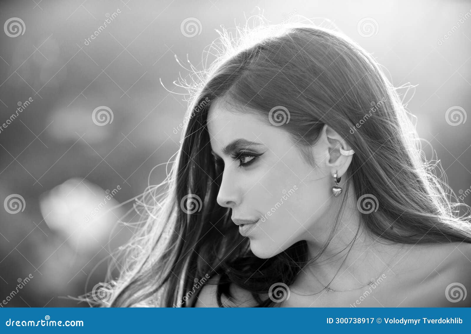 beautiful young woman, tender girl looking eways in summer park. fashion and beauty. young woman on sunny summer day