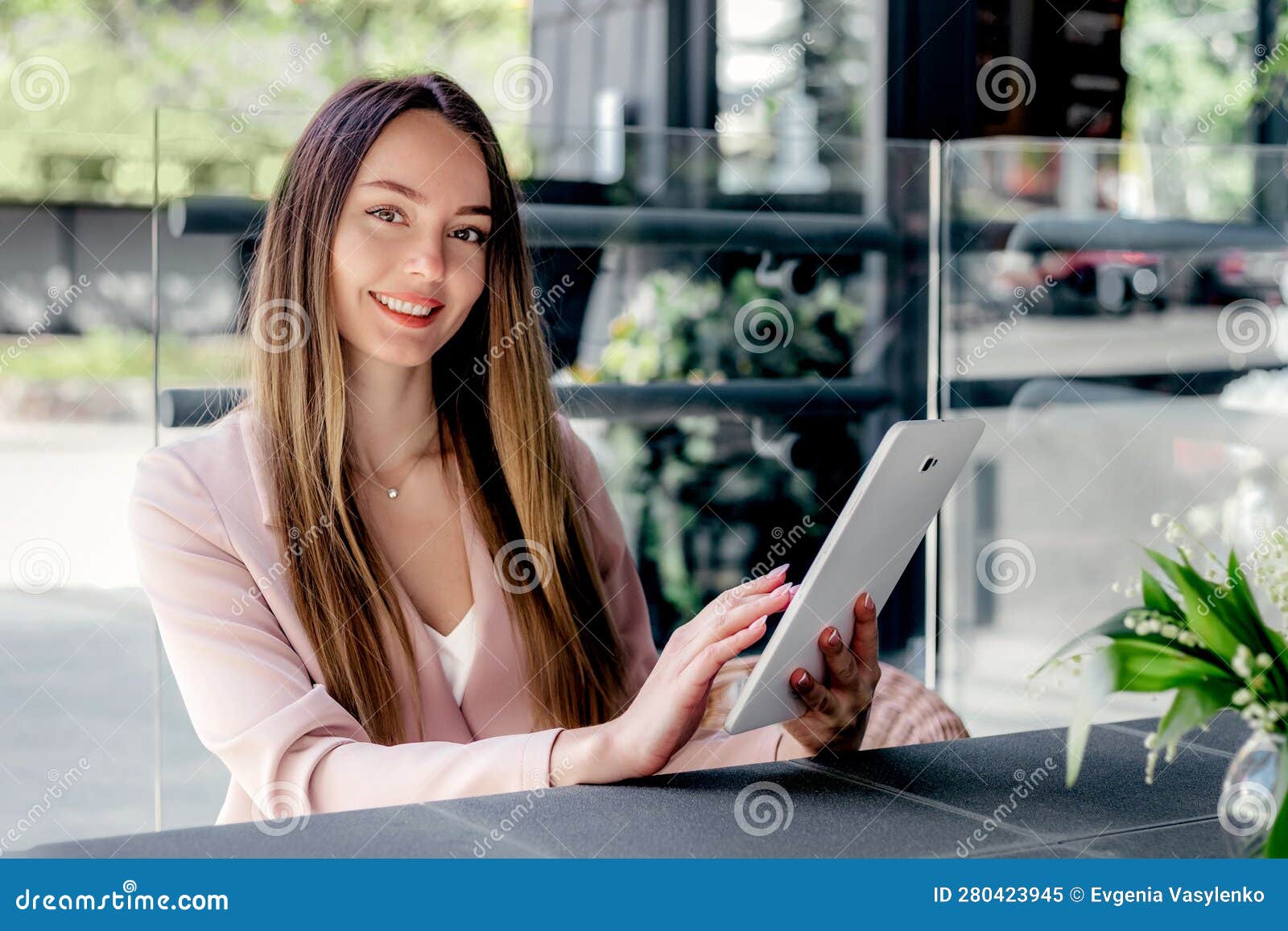 beautiful young woman using digital tablet at cafe