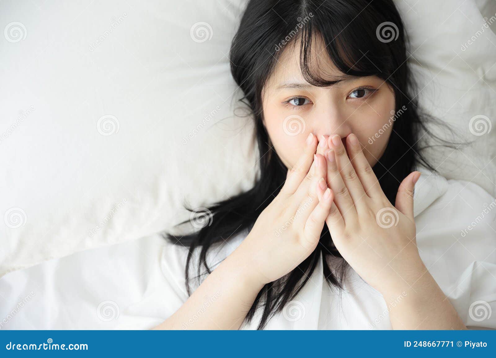 Beautiful Young Woman Waking Up in the Morning at White Bedroom Stock