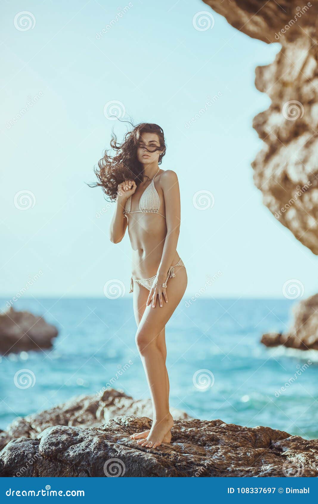 Beautiful Young Woman on Wild Rocky Beach