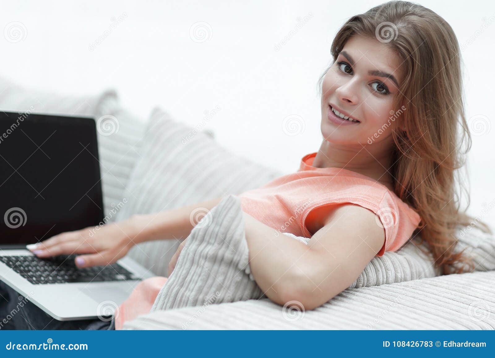 Beautiful Young Woman Working with Laptop Sitting on Sofa and Looking ...