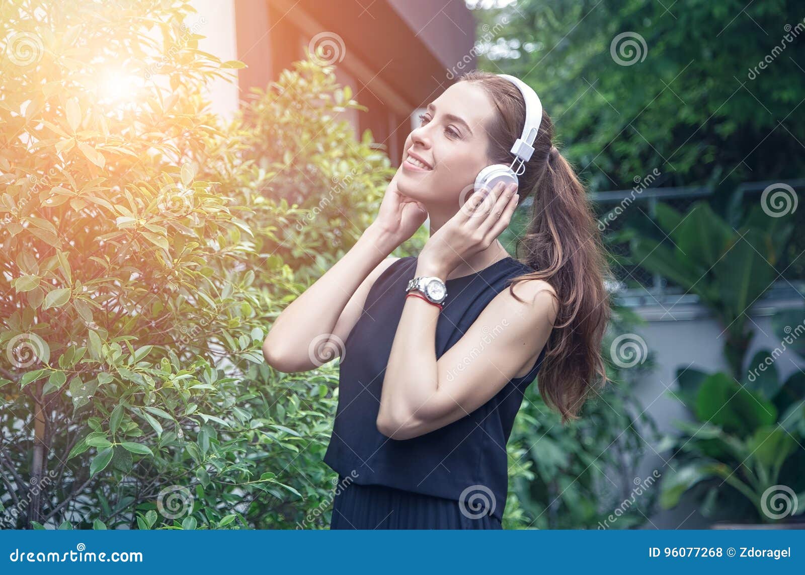 beautiful young women in casual dress, listen to music, in parks