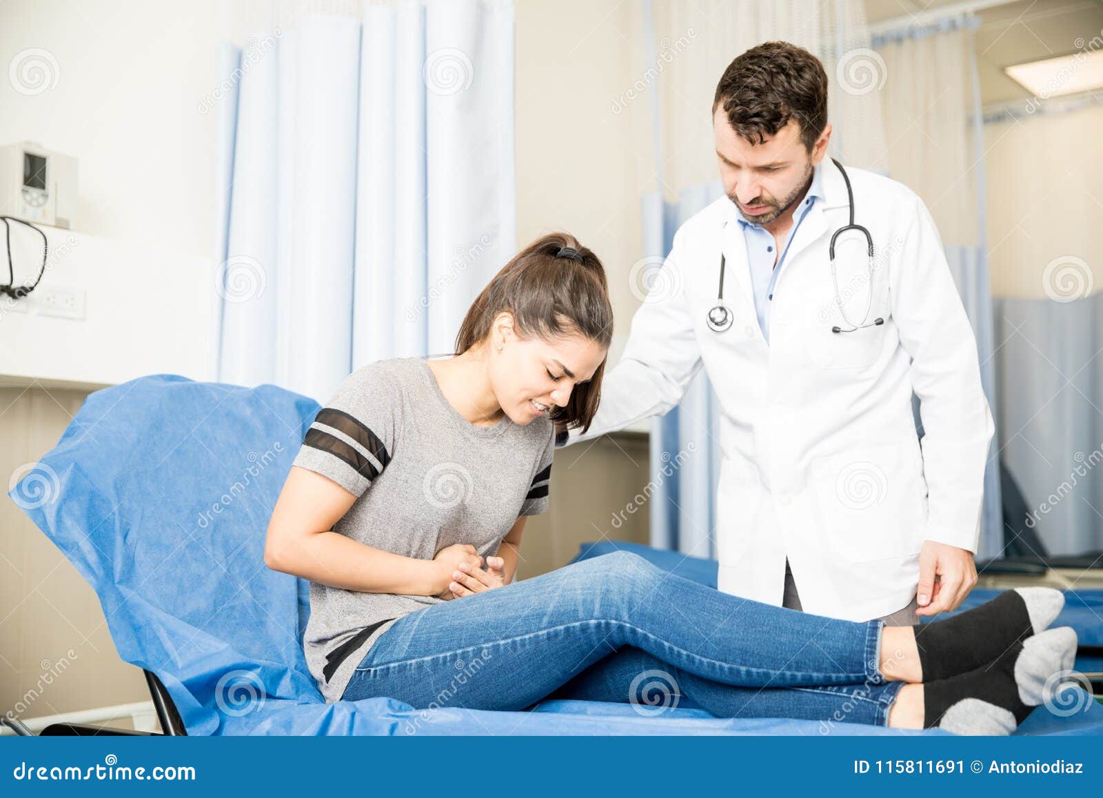 woman with stomach ache visiting doctor
