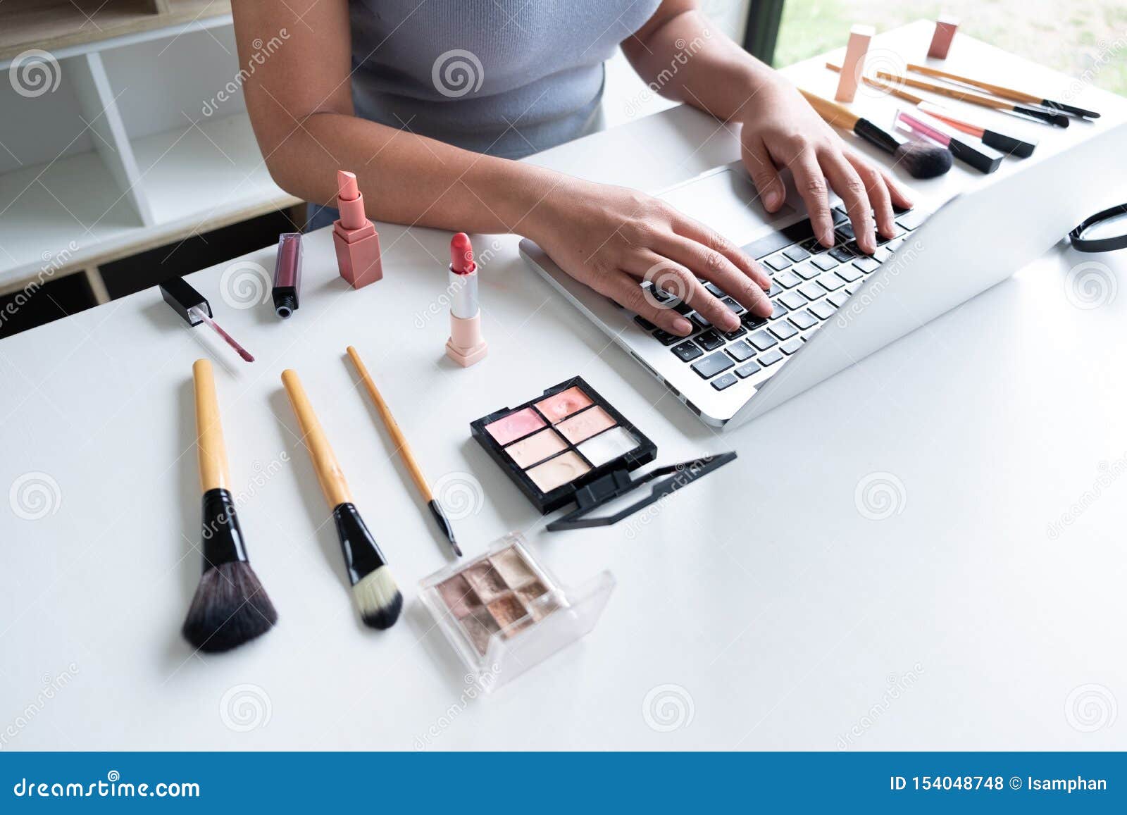 beauty blogger present beauty cosmetics sitting in front tablet. beautiful woman use cosmetics review make up for online