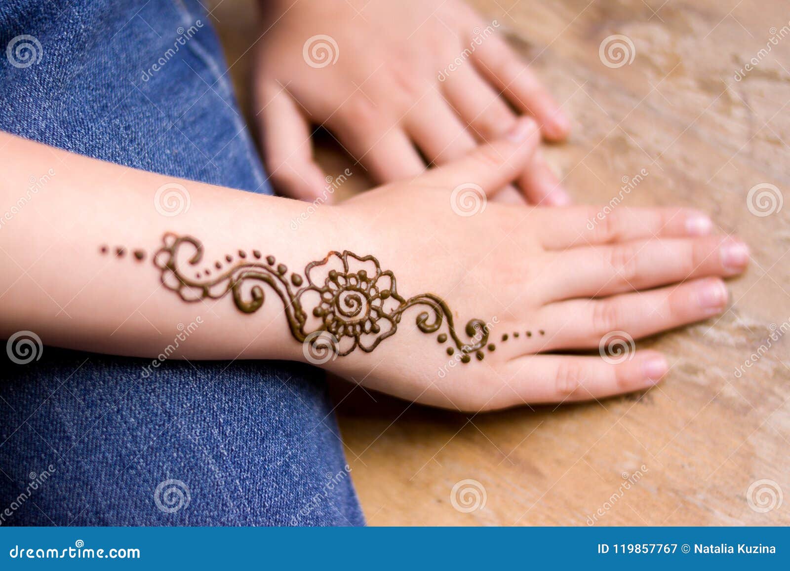 Artist applying henna mehndi tattoo on female hand Stock Photo | Adobe Stock