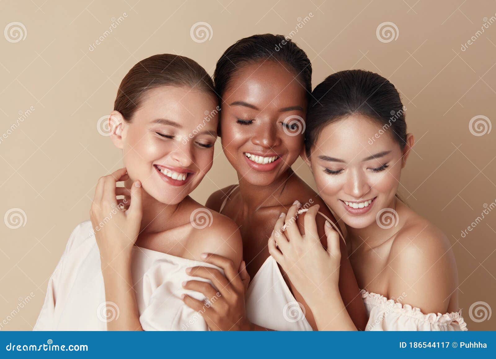 beauty. diverse group of ethnic women portrait. happy different ethnicity models standing together with closed eyes and smiling.