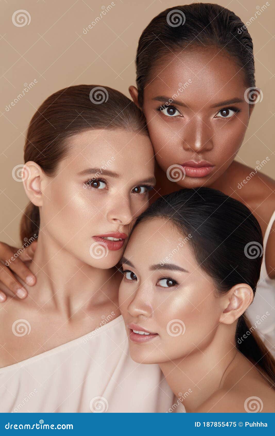 beauty. diverse models portrait. tender caucasian, asian and mixed race women posing together on beige background.