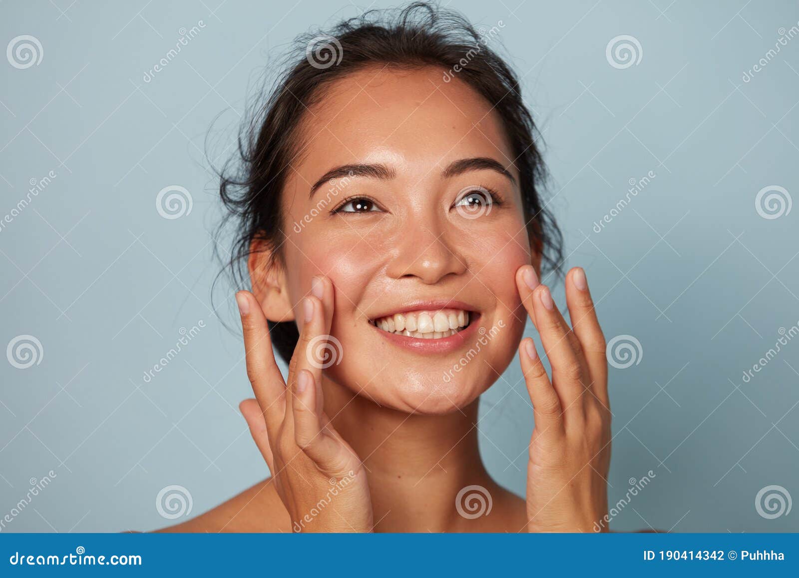 beauty face. smiling asian woman touching healthy skin portrait