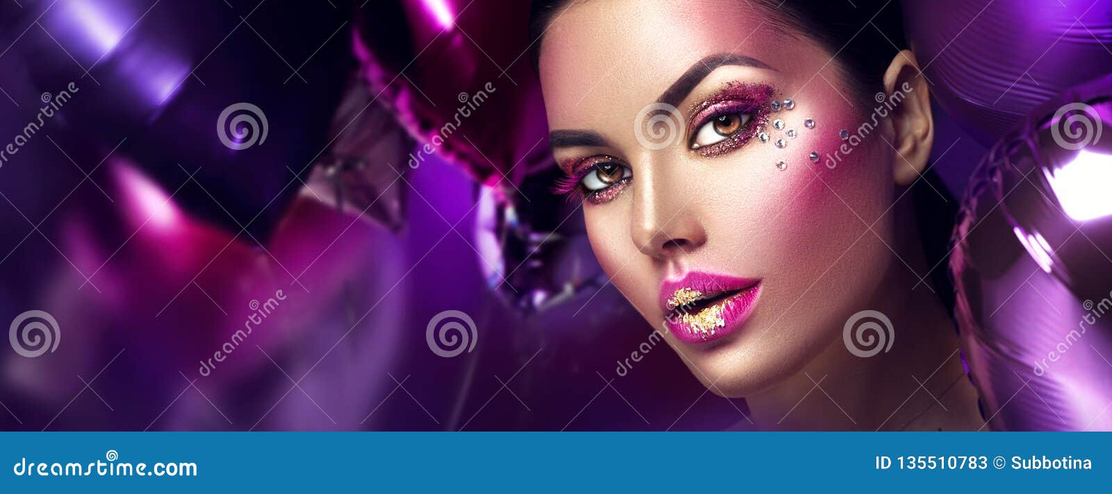 beauty fashion model girl creative art makeup with gems. woman face over purple, pink and violet air balloons