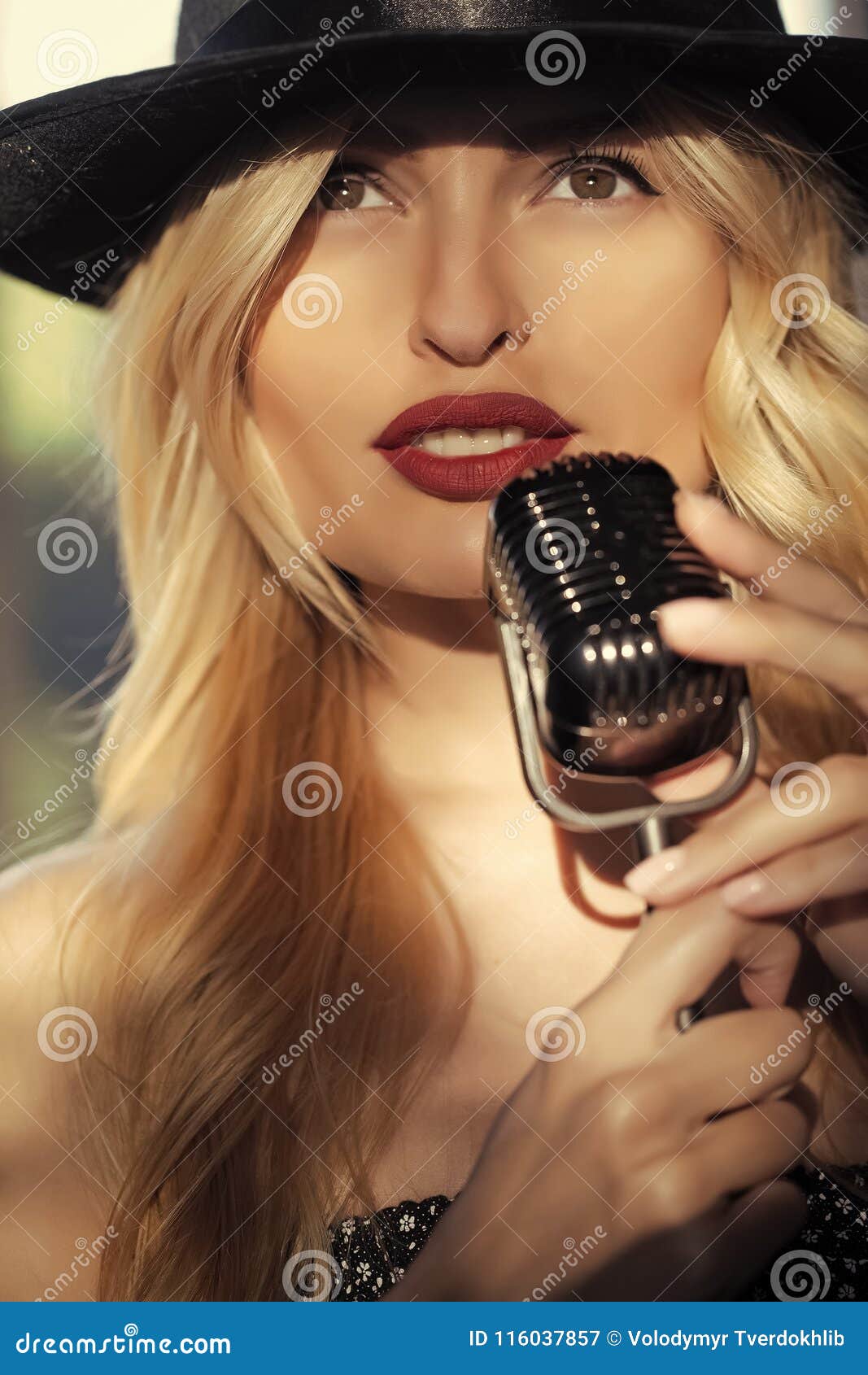 Beauty and fashion, retro and jazz. singer girl in hat with mic. live performance, studio, concert, show. woman with blonde hair and red lips sing in microphone. music and karaoke.