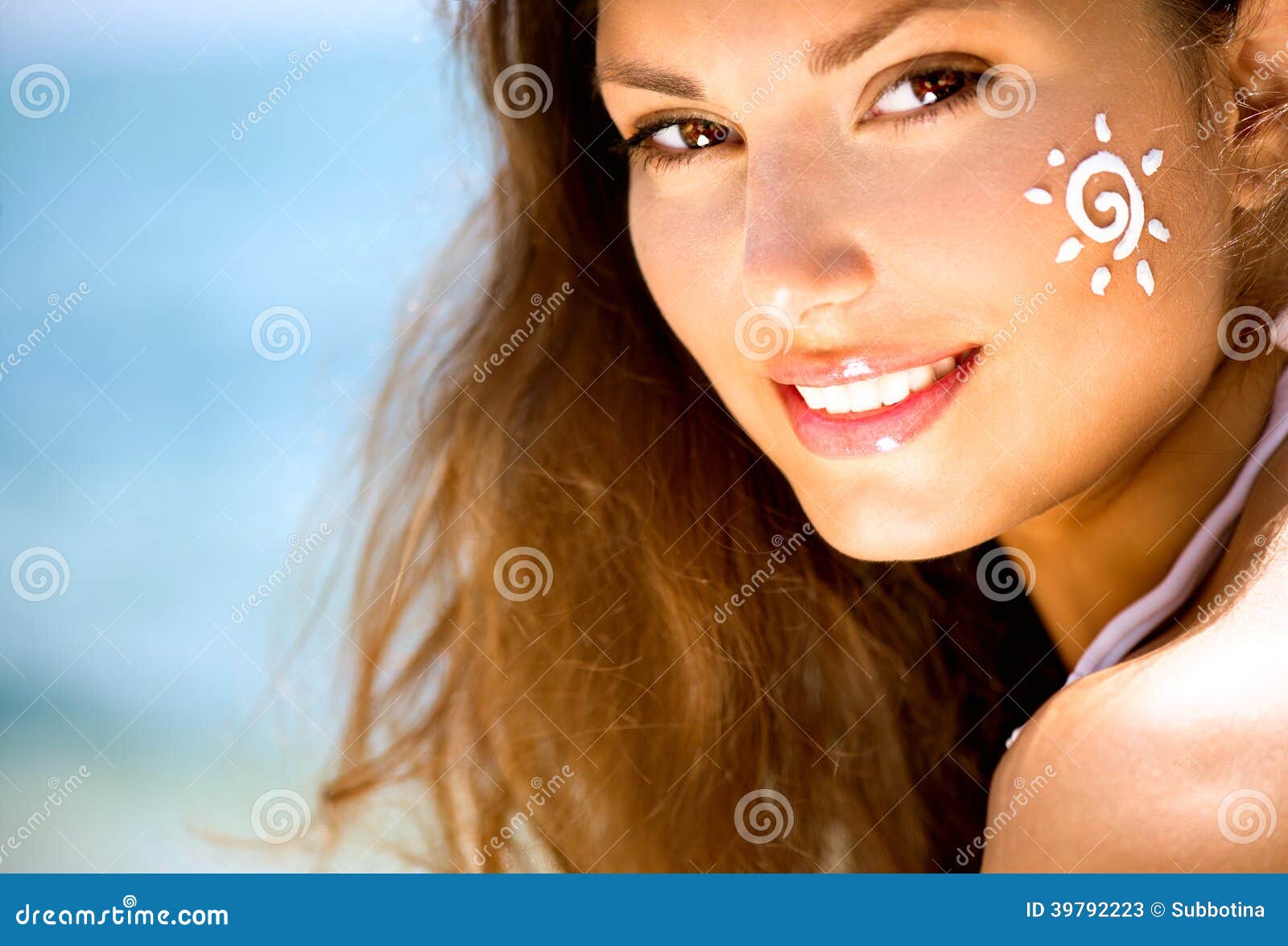 beauty girl with sun tan cream on her face