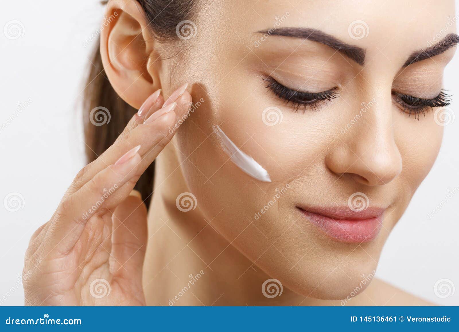 beauty happy young woman applying cream to her face. skincare and cosmetics concept.cosmetics. woman face skin care.spa