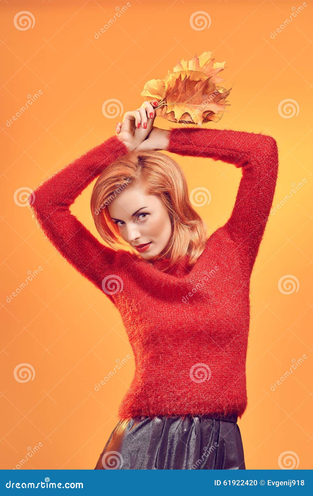 Beauty portrait redhead woman autumn leafs,vintage. Beauty portrait redhead young woman with autumn leafs in hands. Attractive happy playful girl in stylish red sweater. People. Retro, vintage, creative toned, orange yellow background, copyspace