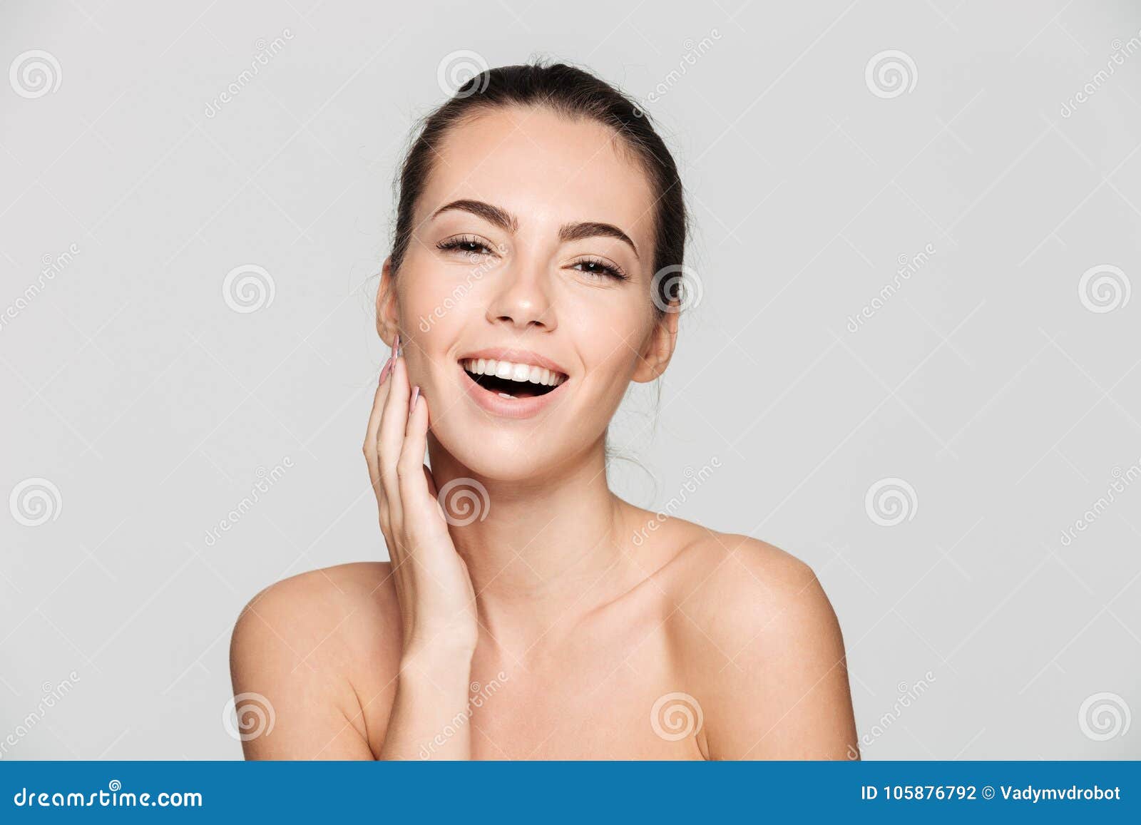 Stock Photo of Half-naked young woman looking at the 