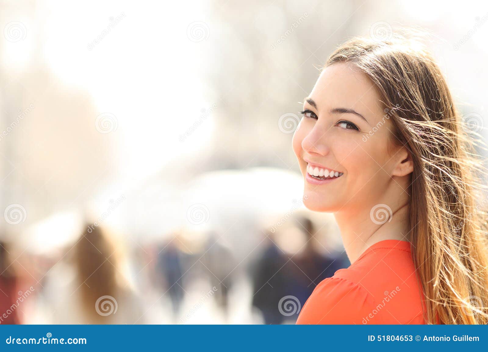 beauty woman with perfect smile and white teeth on the street