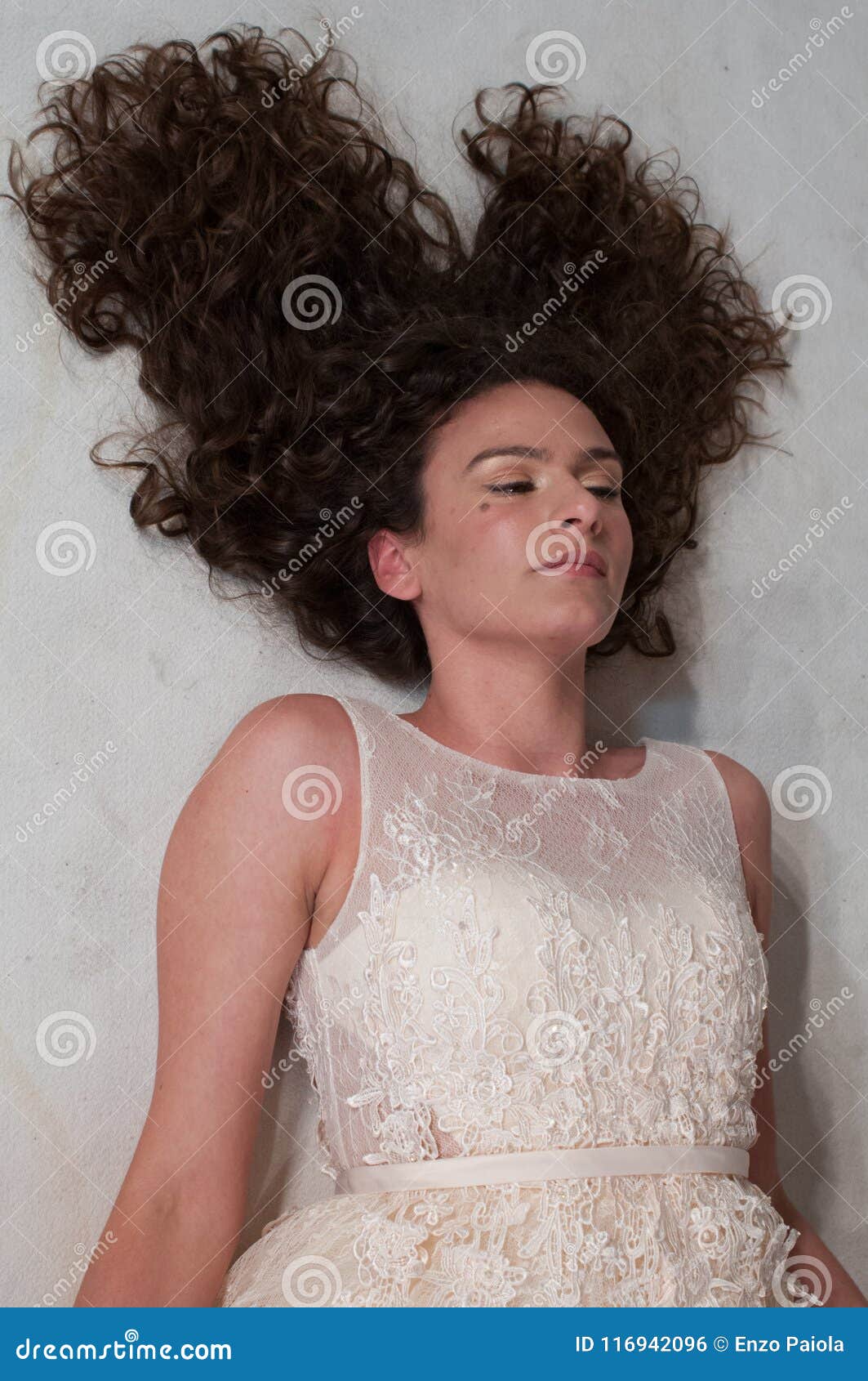 Girl Lying With Long Curly Hair Arranged In A Mane With