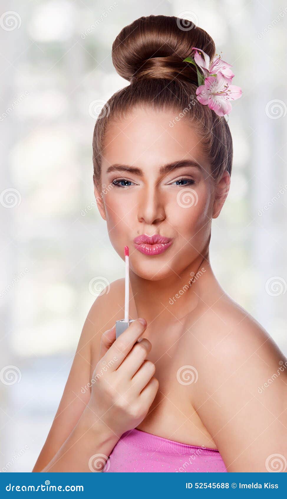 beauty young woman face with lipgloss