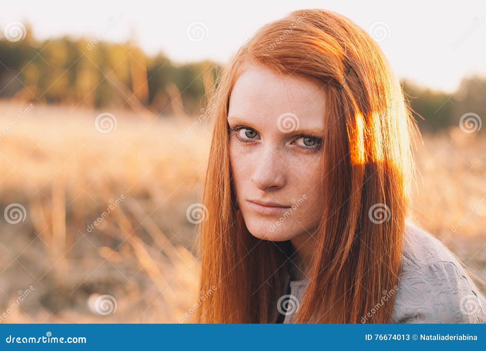 Beauty Young Woman With Red Hair In Golden Field At Sunset 