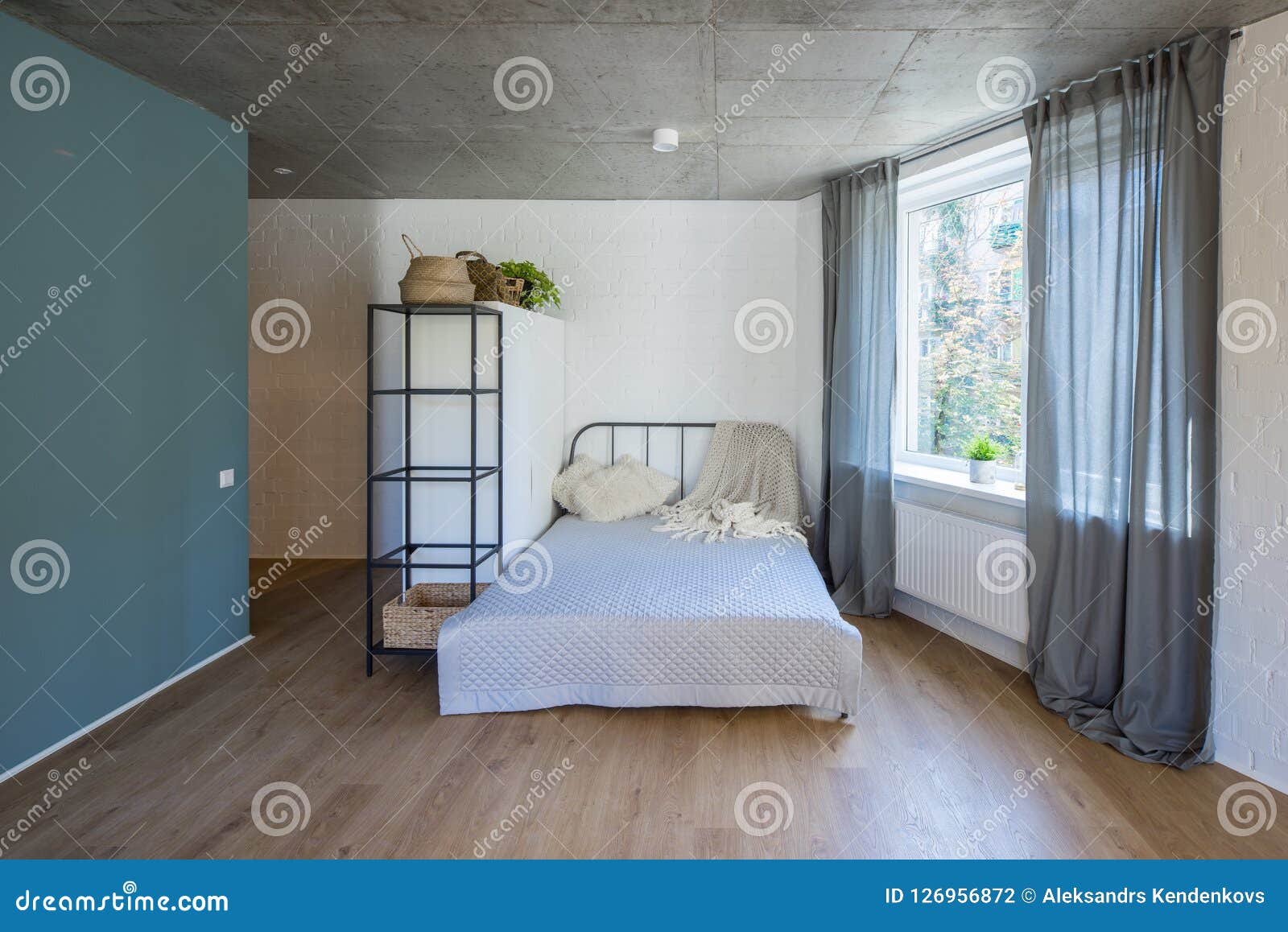 Bed in the Apartment. Bedroom in Studio Apartment. Stock Photo Image