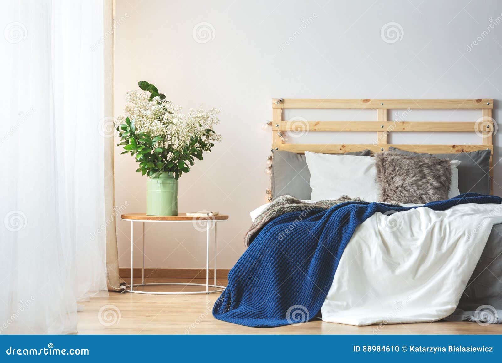 Bed and flowers in bedroom stock photo. Image of furniture 88984610