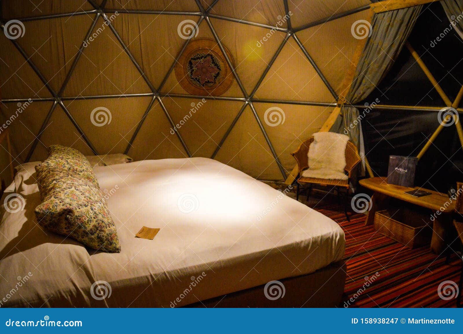 bed and interior of dome on luxury glamping hotel