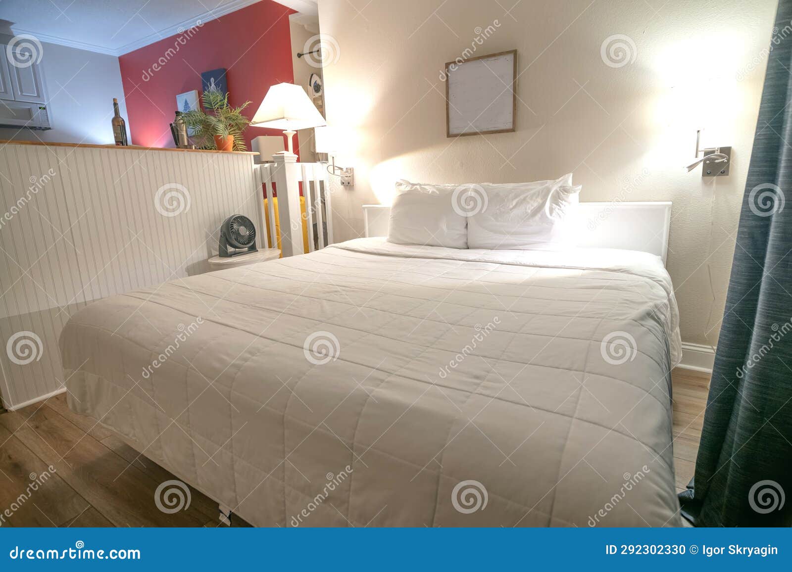 Bed Linen Front View. White Bed with Pillows, Duvet and Bed Sheet Against White Wall, Empty Room