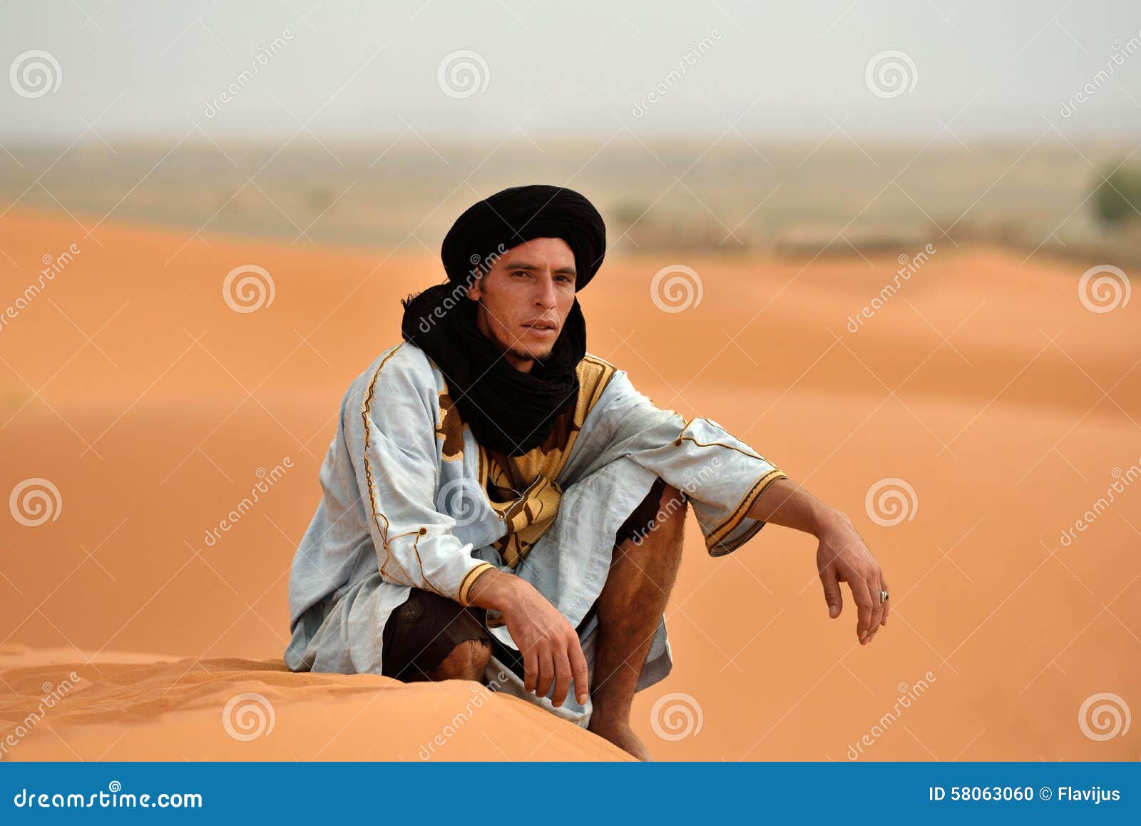 Bedouin Man Wears Traditional Clothing In Sahara Desert 