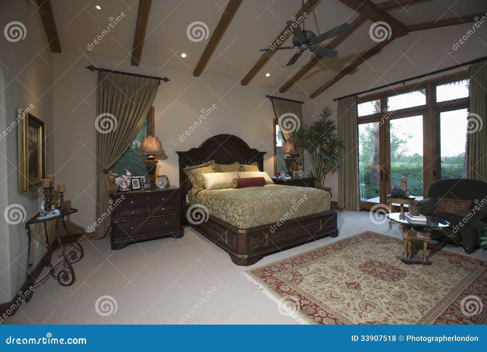 Bedroom with Beamed Ceiling and Patio Doors Stock Photo Image of