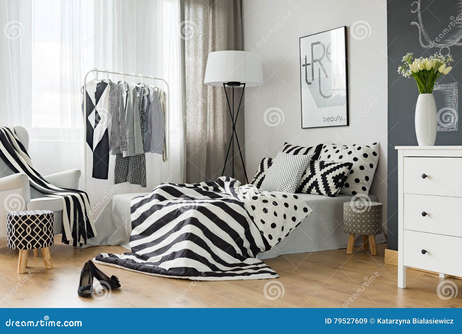 Bedroom with clothes rack stock image. Image of bedding 79527609
