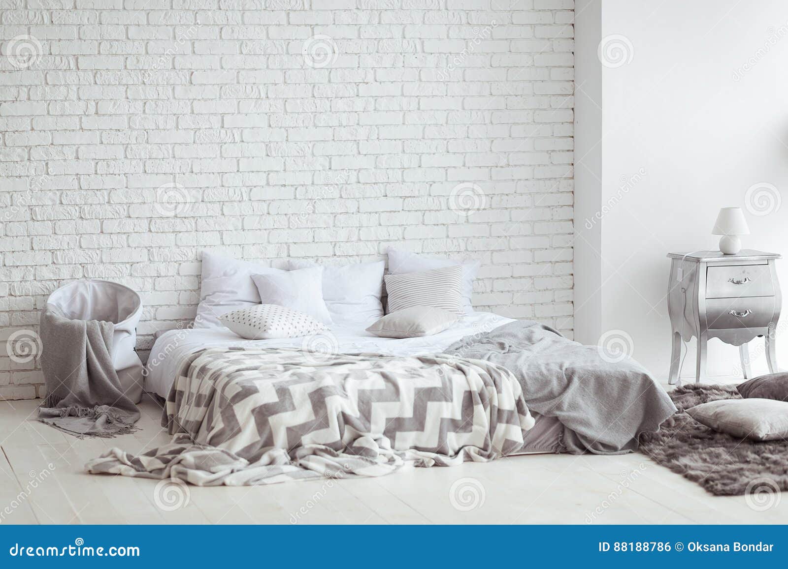 Bedroom Interior with a Brick Wall with a Bed and Bedside Tables Stock