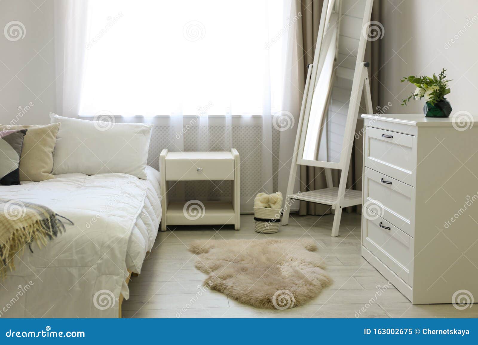 Bedroom Interior With Chest Of Drawers And Mirror Stock Image