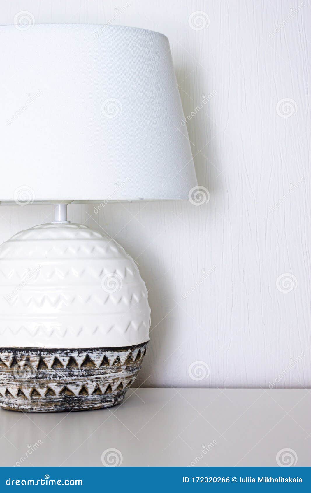 Bedside Lamp with Ceramic Base and Textile Lampshade on the Table Stock