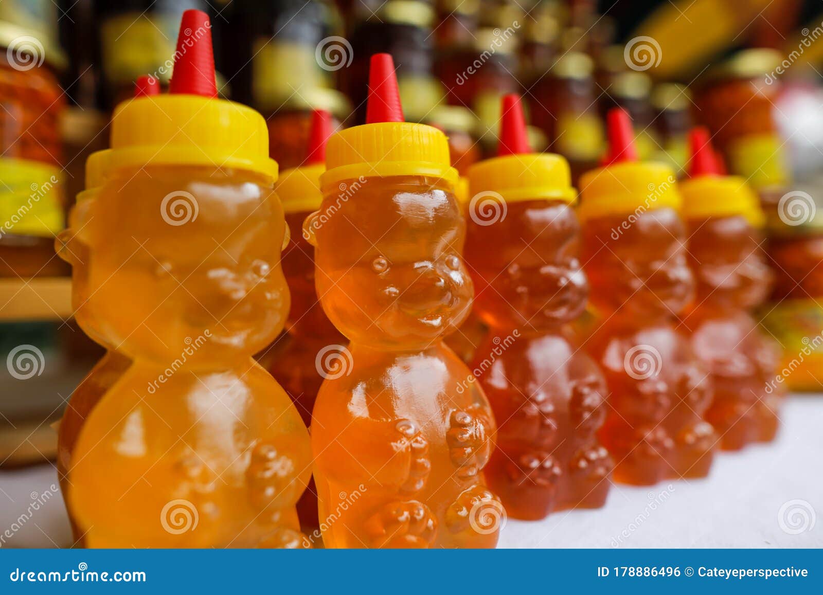 Bee Honey in Plastic Bear Shaped Bottles on Display in a Market Stock