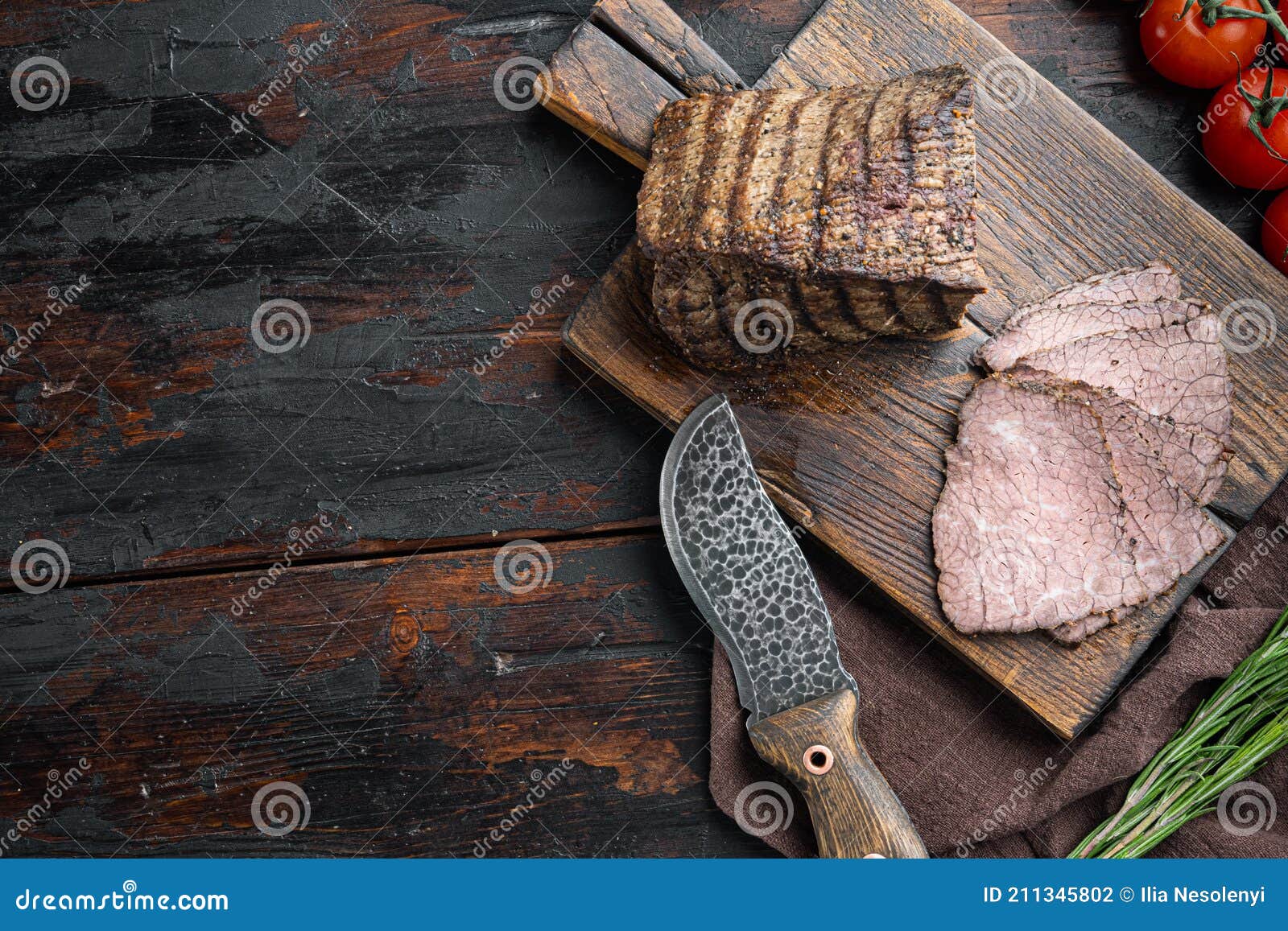 Beef Cold Meat Cut, on Wooden Cutting Board, on Old Dark Wooden Table