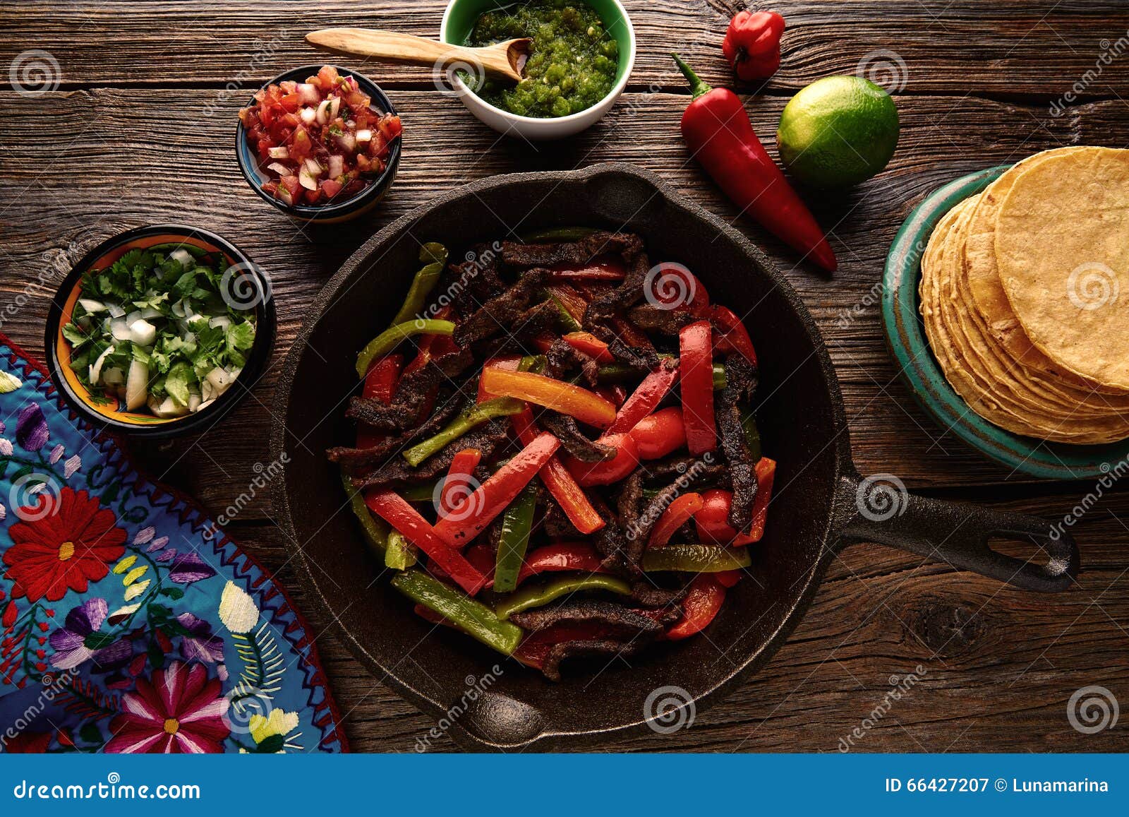 beef fajitas in a pan with sauces mexican food