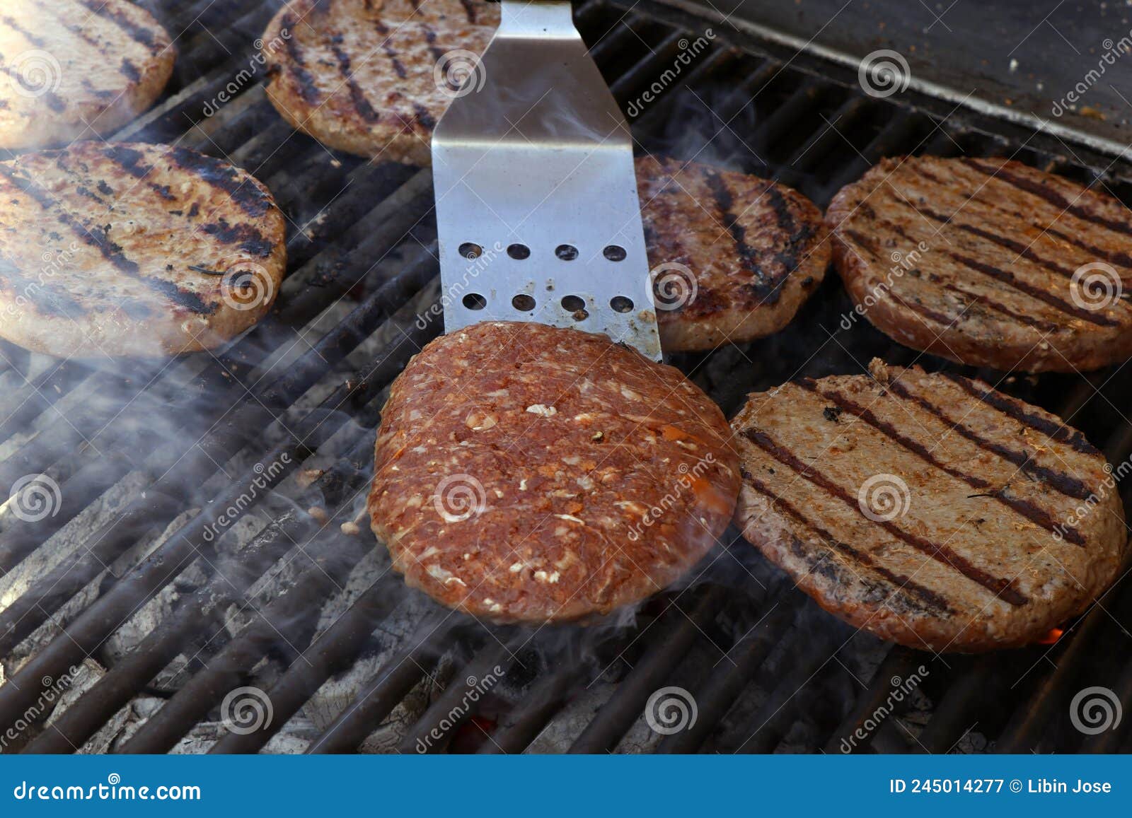 Beef Meat Burger Patty on a Hot Smoky Barbeque Grill Stock Image ...