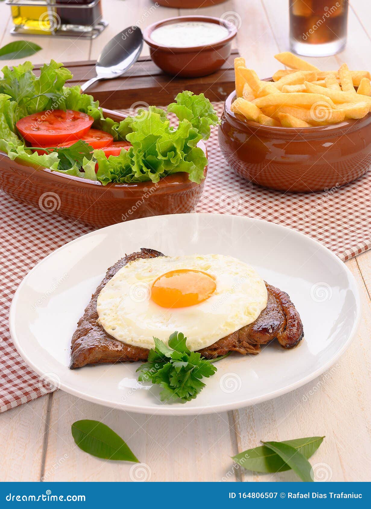 beef steak bife a cavalo - brazilian traditional food steaks, white rice, farofa and salad
