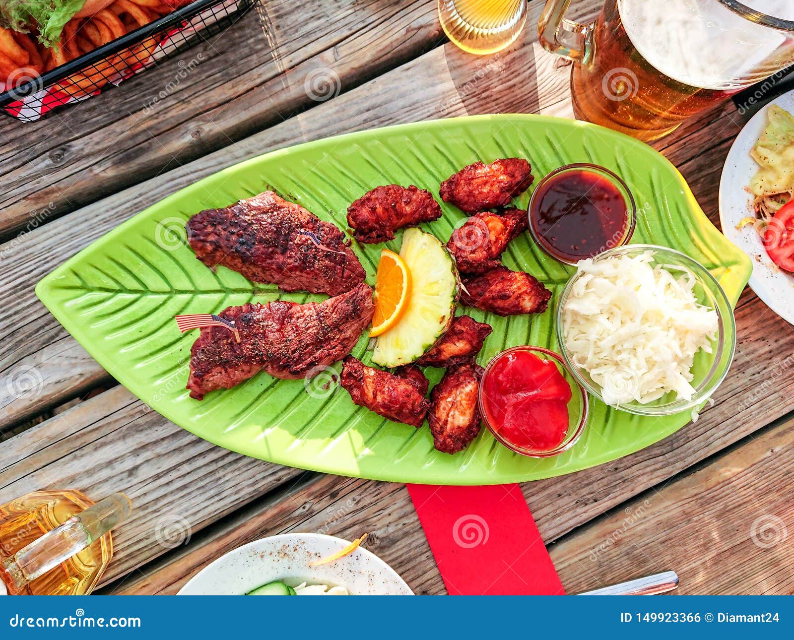 Beef Steak with Chicken Wings and White Cabbage Salad Stock Photo