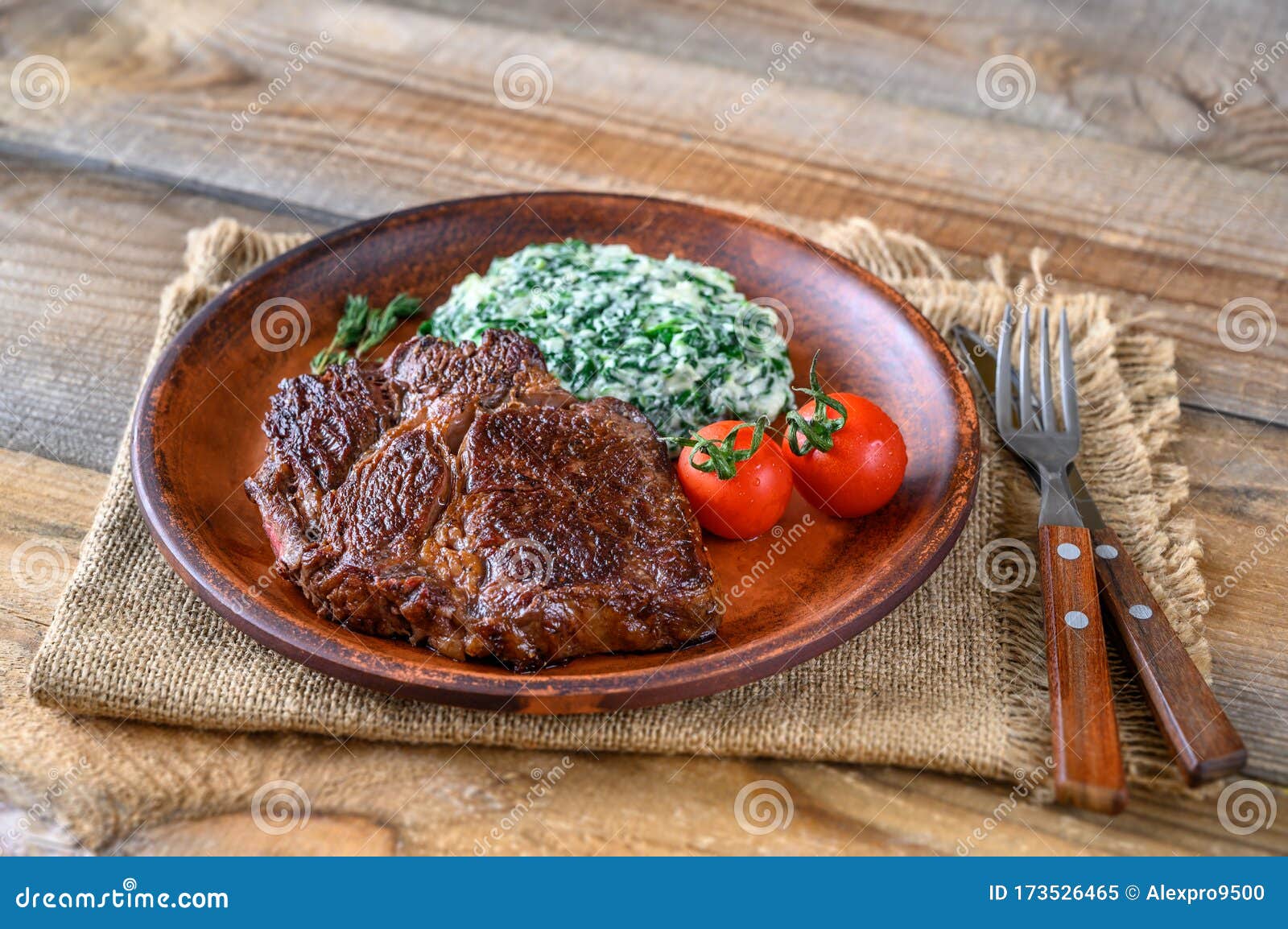 Beef Steak with Creamy Spinach Stock Image - Image of rustic, board