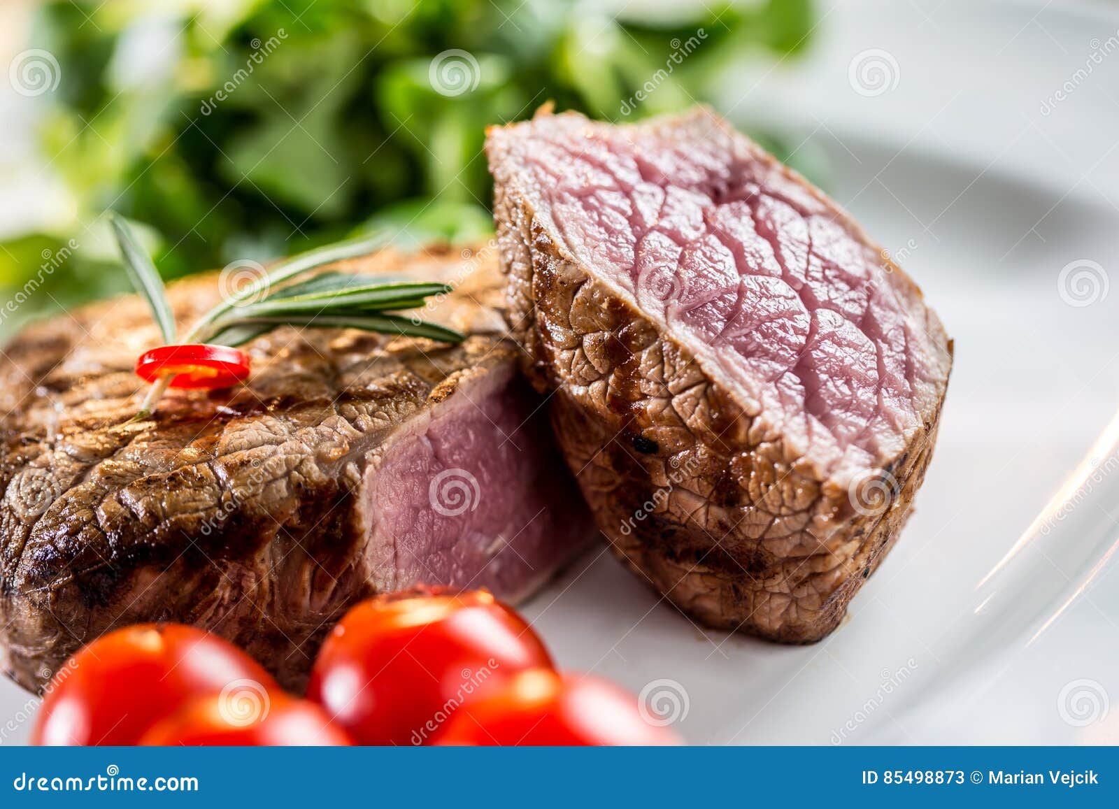 beef steak. juicy beef steak. gourmet steak with vegetables and glass of rose wine on wooden table