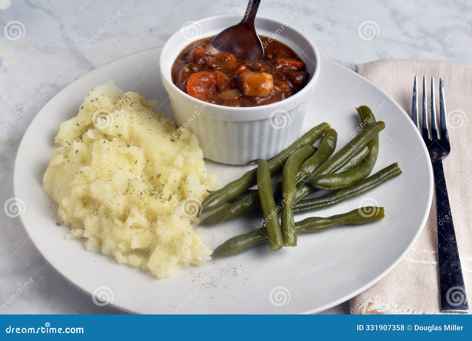 beef stew served with mash potatoes and green beans