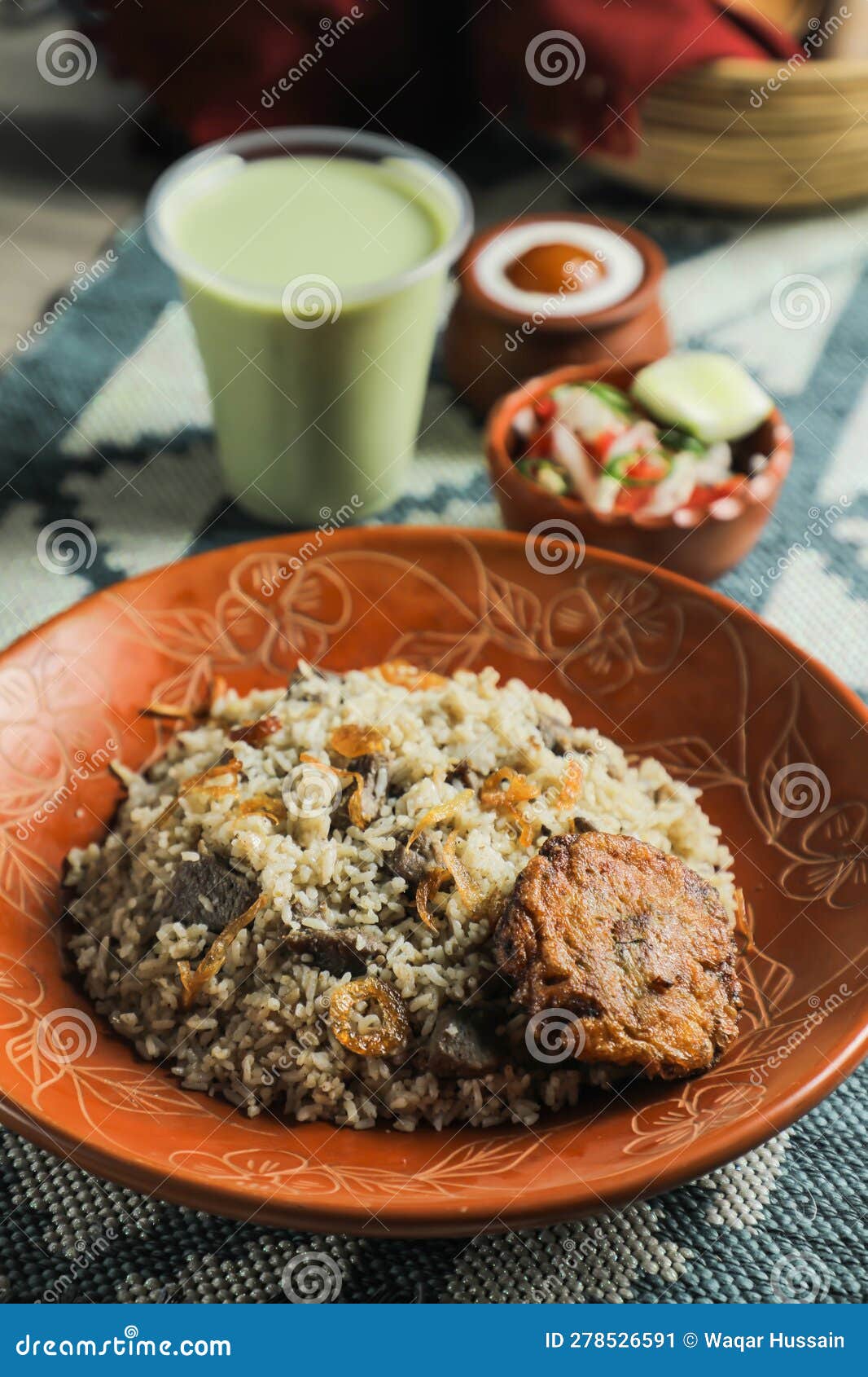 beef tehari combo with shami kabab tikki, salad, borhani and baked gulab jamun served in dish  on mat top view of indian