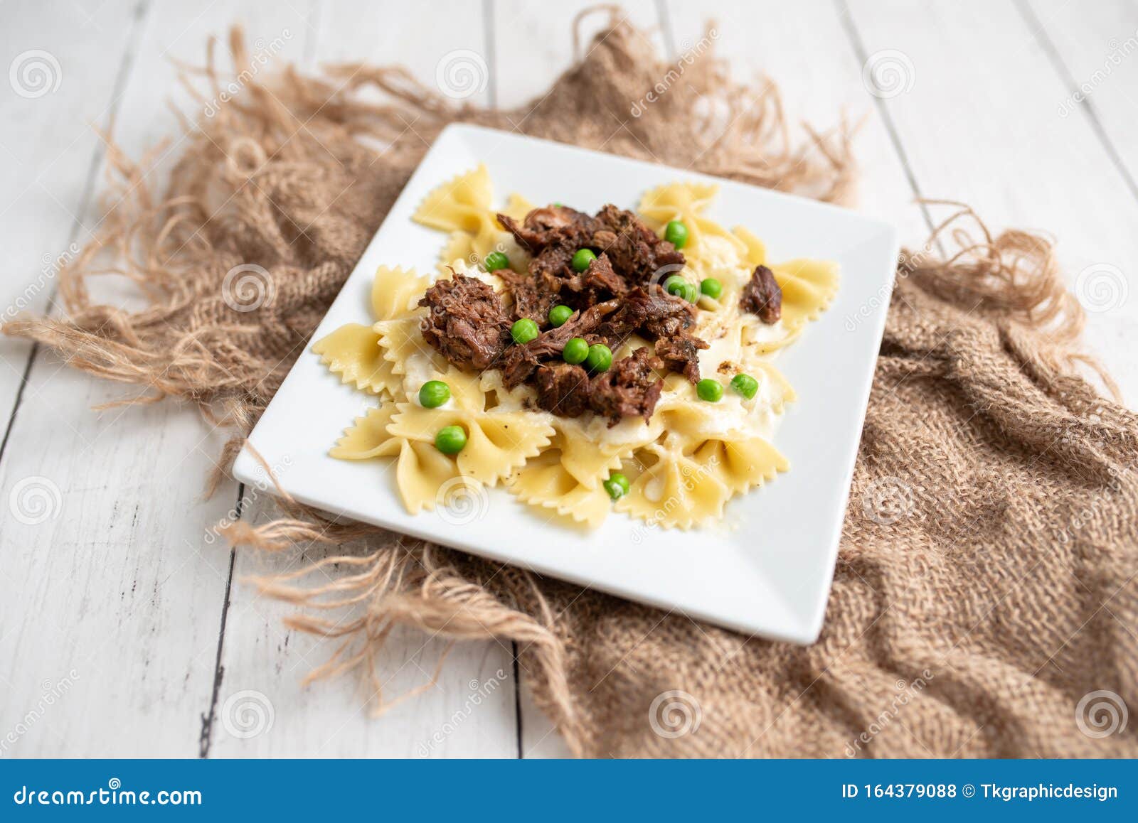 Beef Tips Over Bow Tie Pasta and Alfredo Sauce Stock Photo Image of