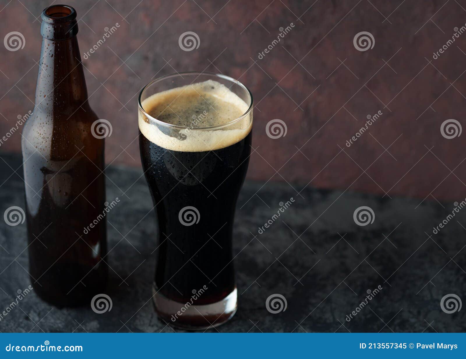 Beer Bottle and Glass with Dark Beer Porter or Stout Stock Image