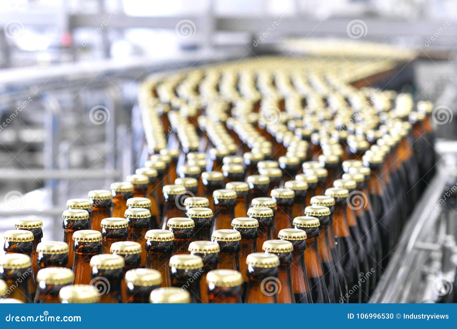 beer filling in a brewery - conveyor belt with glass bottles