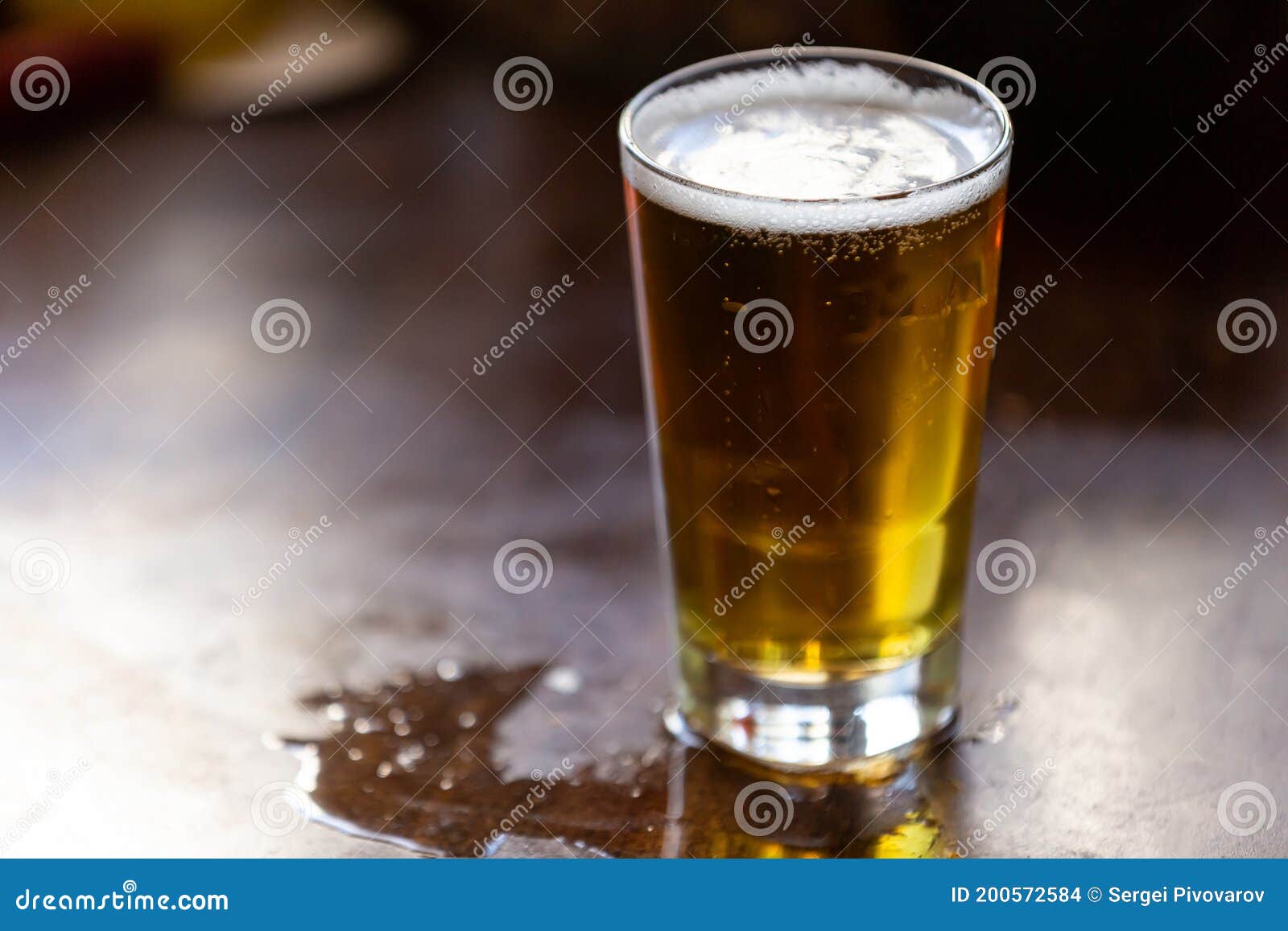 Beer in a Glass Stands on a Bar Counter with Copy Space Stock Photo
