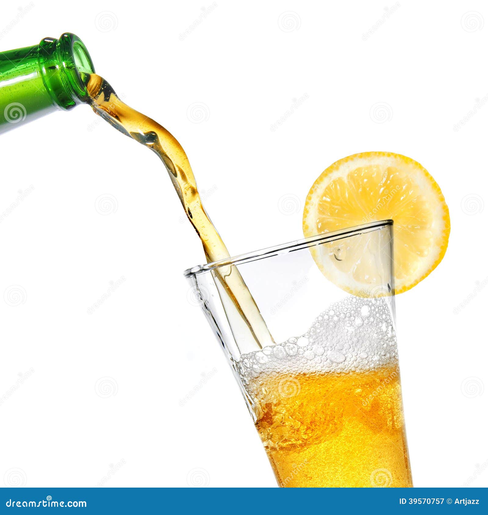 Beer pouring from bottle into glass with lemon isolated on white