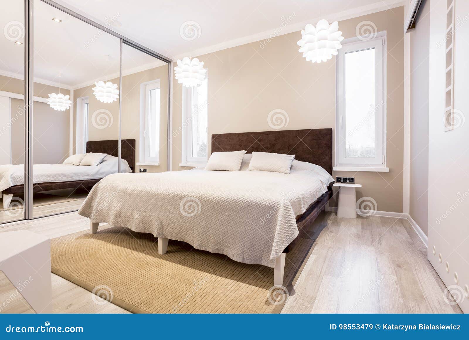 beige bedroom with mirror wardrobe